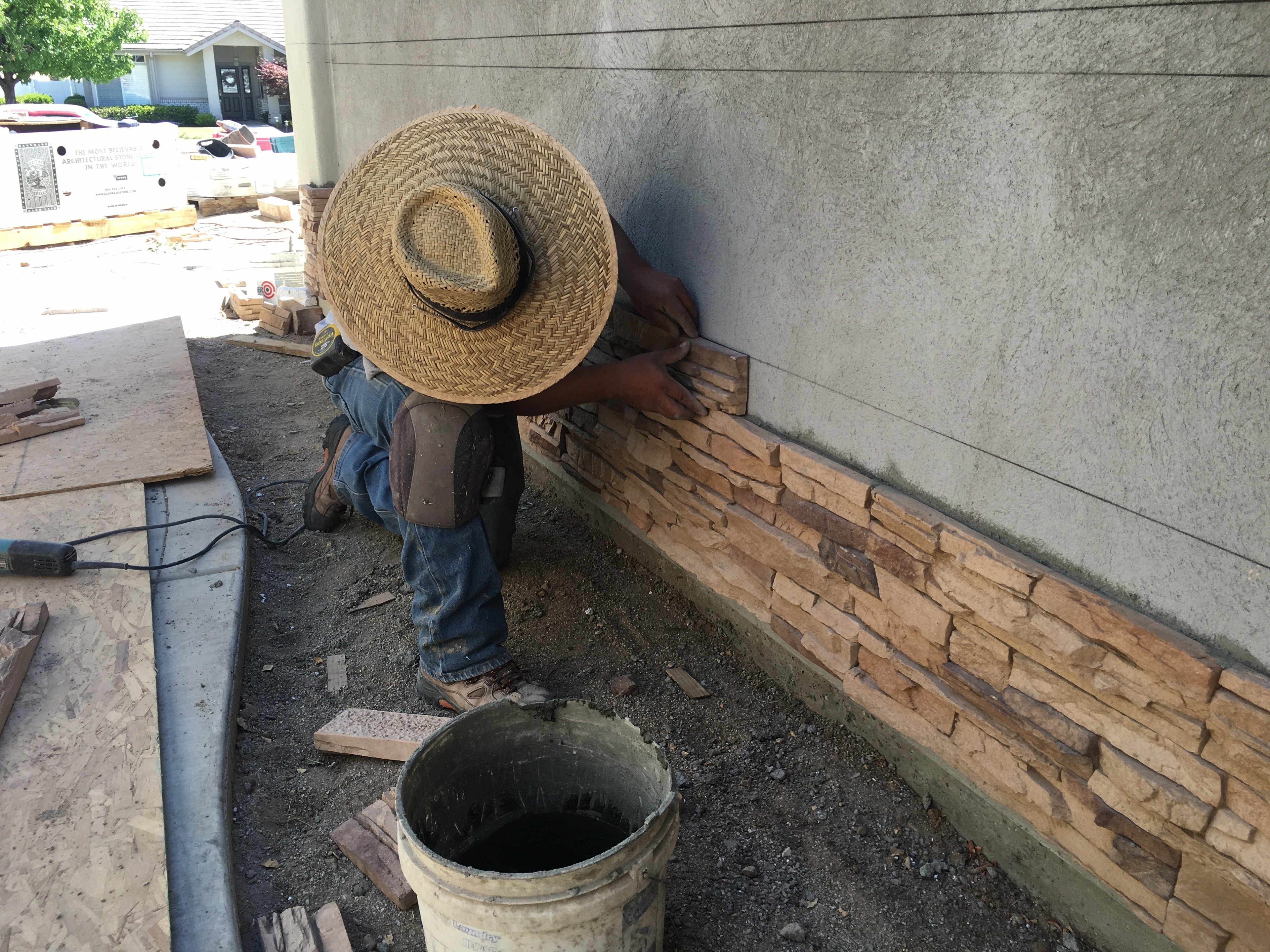 Stone veneer installation on exterior wall by Capps Construction craftsman