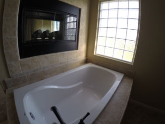 Master bath with grand soaker bathtub and recessed fireplace